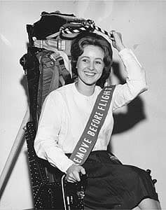 A woman poses in a Martin-Baker seat